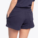 Woman wearing the Osaka women shorts in navy with white logo. Back view