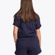 Woman wearing the Osaka women shorts in navy with white logo. Back view