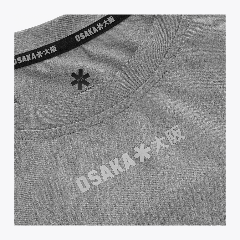 Reflective Osaka Osaka chest logo detail on the Osaka Men’s Apex Training Tee in Quiet Gray athletic performance shirt.