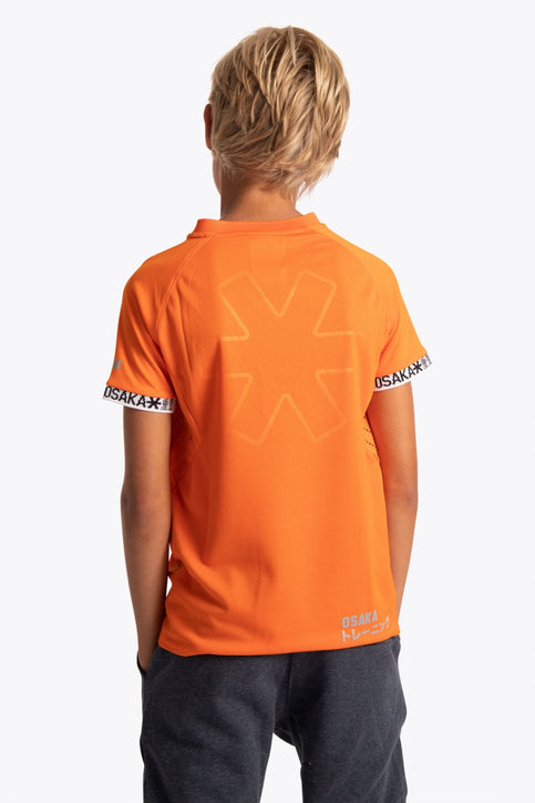 Osaka Kids Jersey | Orange Boy wearing the Osaka Kids Jersey in Orange. Front view