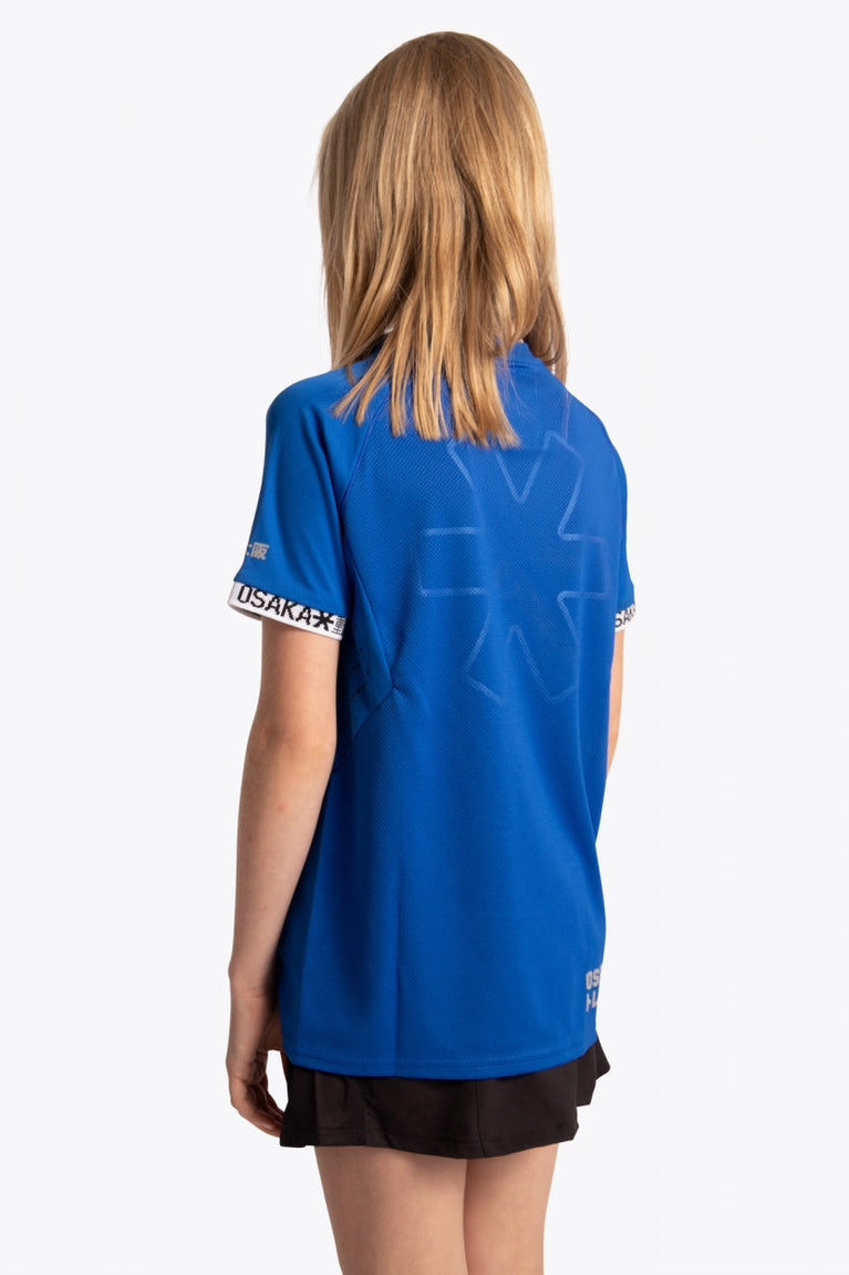 Girl wearing the Osaka Kids Jersey in Royal blue. Back view