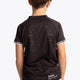 Boy wearing the Osaka Kids Jersey in Black. Back view