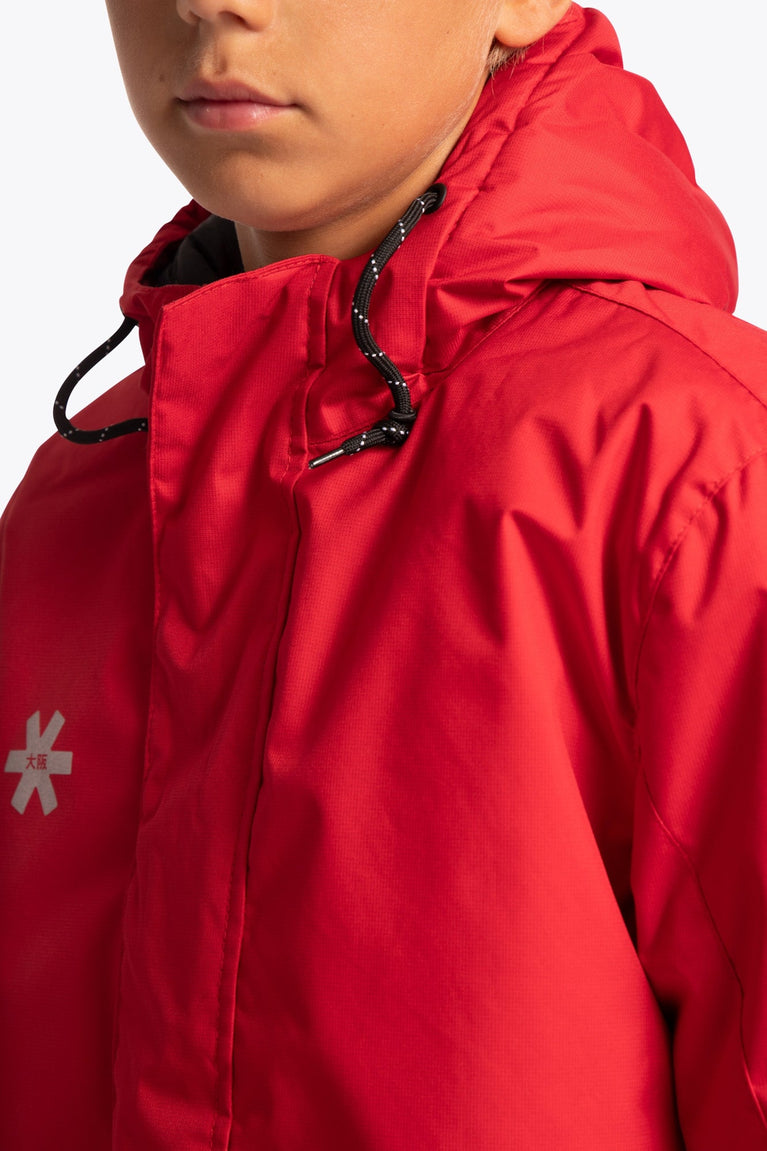 Boy wearing the Osaka Kids Stadium Jacket in Red. Front detail neck view