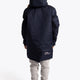 Boy wearing the Osaka Kids Stadium Jacket in Navy. Back view