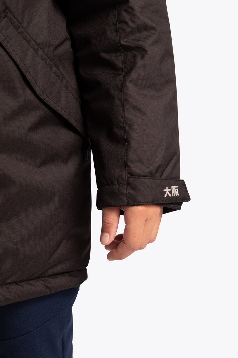 Osaka Kids Stadium Jacket in Black. Detail logo sleeve view
