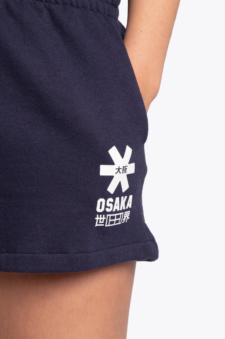 Woman wearing the Osaka women shorts in navy with white logo. Front detail logo view
