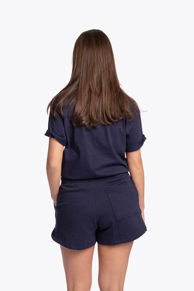 Woman wearing the Osaka women shorts in navy with white logo. Back view