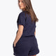 Woman wearing the Osaka women shorts in navy with white logo. Back view