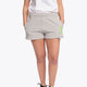 Woman wearing the Osaka women shorts in grey with neon green logo. Front view