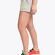 Woman wearing the Osaka women shorts in grey with neon green logo. Side view