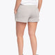 Woman wearing the Osaka women shorts in grey with neon green logo. Back view