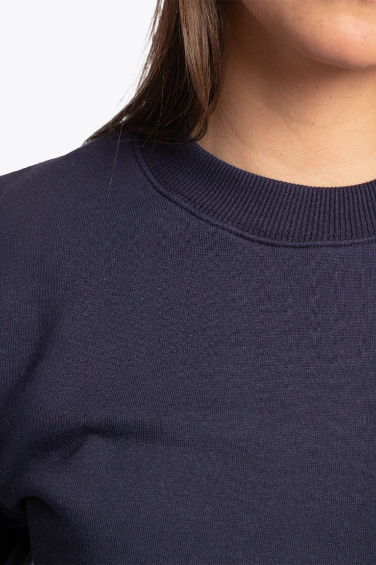 The Osaka navy basic unisex sweater with logo in white. Front detail neck view