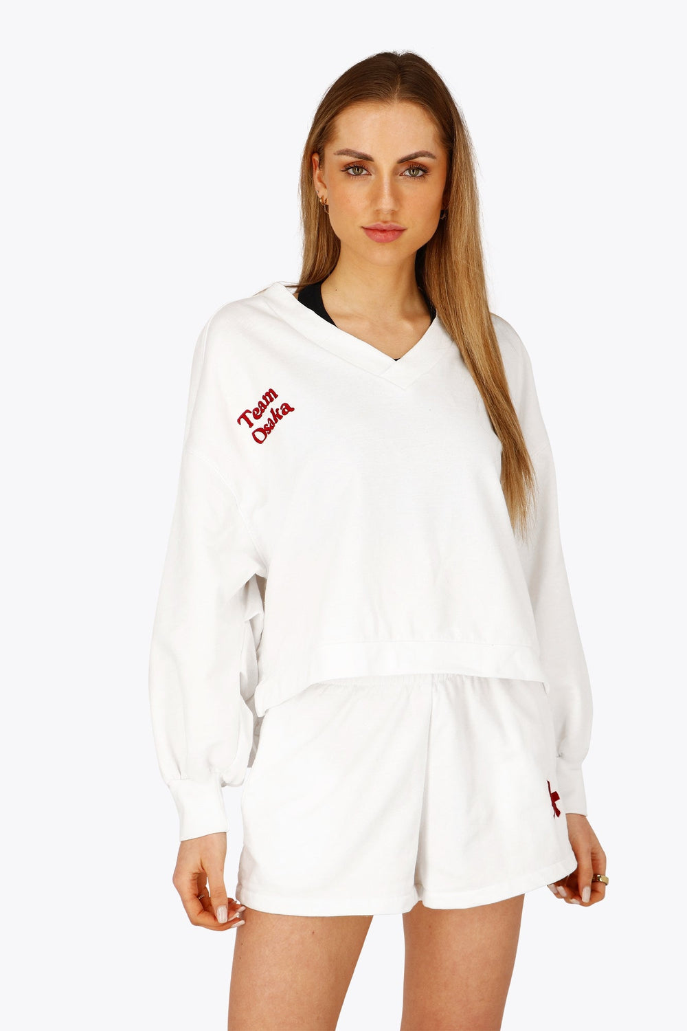 Osaka women v-neck cropped sweater white with logo in red. Front flatlay view