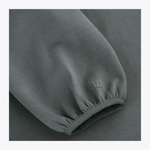Dark grey melange unisex hoodie sleeve cuff with small embroidered emblem #DarkGreyMelange