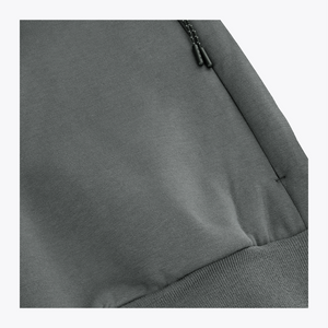 Unisex sweater detail: dark grey melange hem with ribbing and small draw-cord hardware #DarkGreyMelange