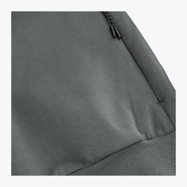 Unisex sweater detail: dark grey melange hem with ribbing and small draw-cord hardware #DarkGreyMelange