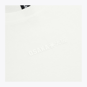 Close-up of a white boxy crewneck sweatshirt with embossed 'OSAKA**大阪' text on the chest and a black neck label reading 'OSAKA'. | Osaka World USA #White