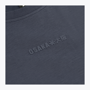 Close-up of a navy crewneck sweatshirt with embossed 'OSAKA**大阪' text on the chest and a black neck label reading 'OSAKA'.  | Osaka World USA #Navy