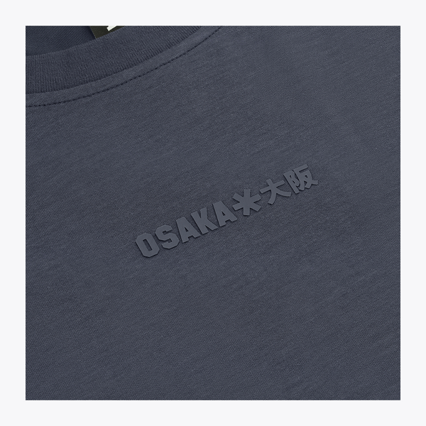 Close-up of a navy crewneck sweatshirt with embossed 'OSAKA**大阪' text on the chest and a black neck label reading 'OSAKA'.  | Osaka World USA #Navy