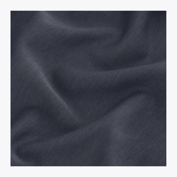 A close-up of navy fabric with soft folds and a smooth texture, presented as a material or color sample. | Osaka World USA #Navy