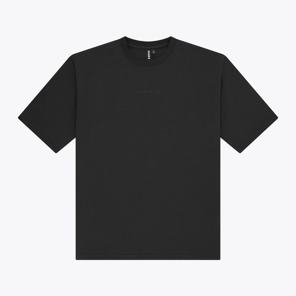 A black boxy crewneck t-shirt with a small, tonal embroidered logo on the center chest, displayed flat against a light gray background. | Osaka World USA #Black