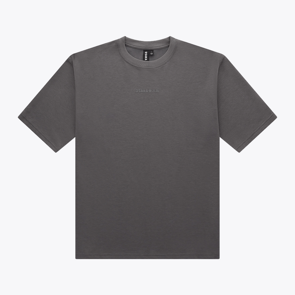 A dark gray crewneck t-shirt with a small, tonal embroidered logo on the center chest, displayed flat against a light gray background. | Osaka World USA #DarkGrey
