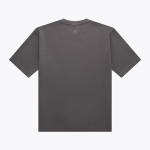 A dark gray short-sleeve t-shirt shown from the back, featuring a small tonal embroidered logo centered below the neckline, set against a plain white background. | Osaka World USA #DarkGrey