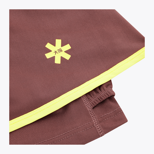 Osaka Women Floucy Active Skort| #Peppercorn | Close up of front logo
