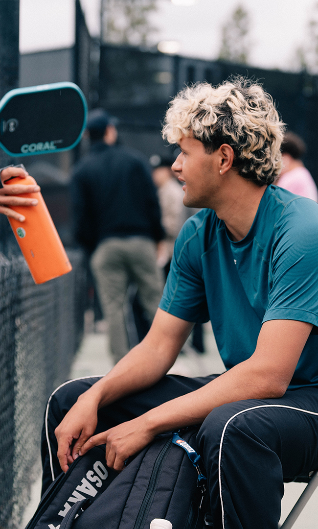 Andrew_Garcia_Osaka_pickleball_athlete_taking_a_courtside_break_between_matches
