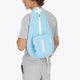 Osaka neoprene padel bag in light blue with logo in white. Man wearing the bag
