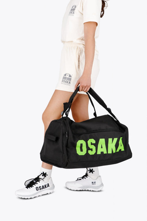 Osaka sports duffel bag in black with logo in green. Front view