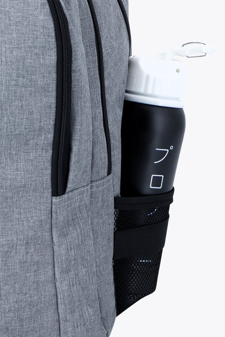 Osaka sports backpack in light grey with logo in blue. Water bottle holder view