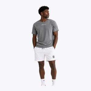 Black male model wearing Osaka Men’s Apex Training Tee in Quiet Gray and white training shorts, showcasing reflective chest branding, athletic fit, and breathable training fabric. #QuiteGray