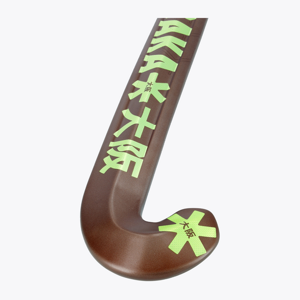 Field hockey stick curved blade end in dark brown with large lime emblem and logo. #GreenAsh