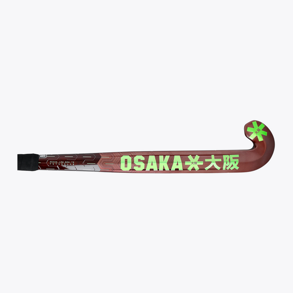 Field hockey stick horizontal view: dark brown shaft with OSAKA text and lime end mark. #GreenAsh