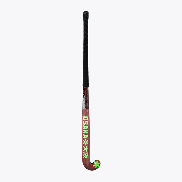 Field hockey stick upright view: dark brown blade with lime cross/star accents and black handle. #GreenAsh