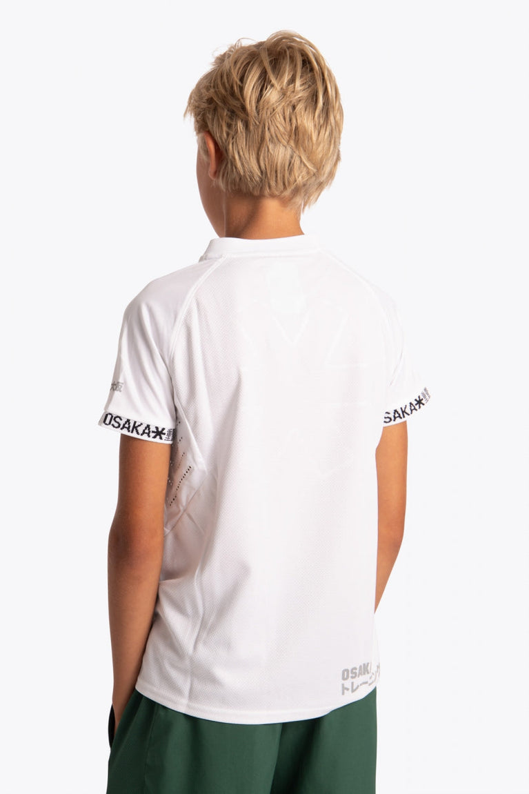 Boy wearing the Osaka Kids Jersey in white. Back view