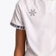 Boy wearing the Osaka Kids Jersey in white. Front detail logo view