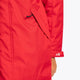 Boy wearing the Osaka Kids Stadium Jacket in Red. Front detail pocket view