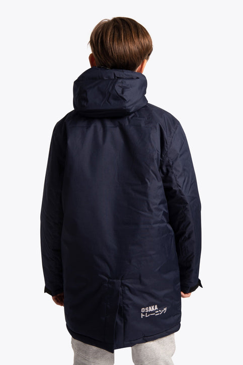 Boy wearing the Osaka Kids Stadium Jacket in Navy. Front view