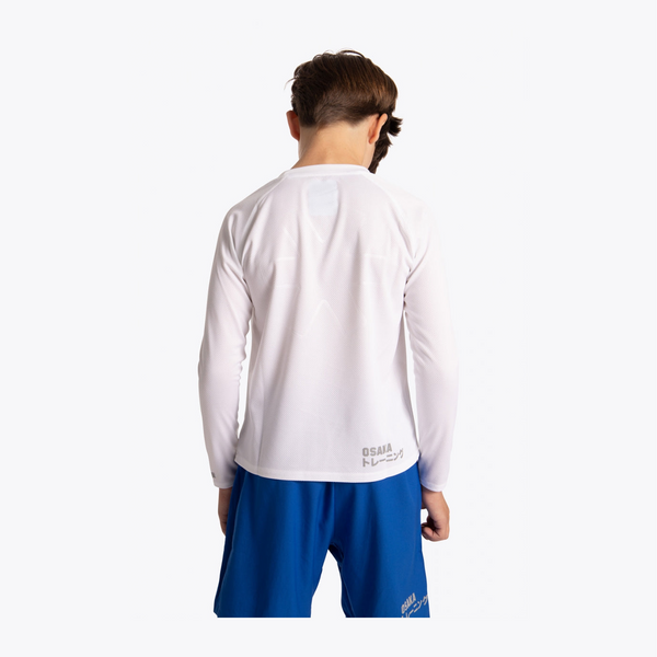 A child model shown from the back wearing a white long-sleeve athletic shirt and blue shorts against a plain light gray studio background. #White