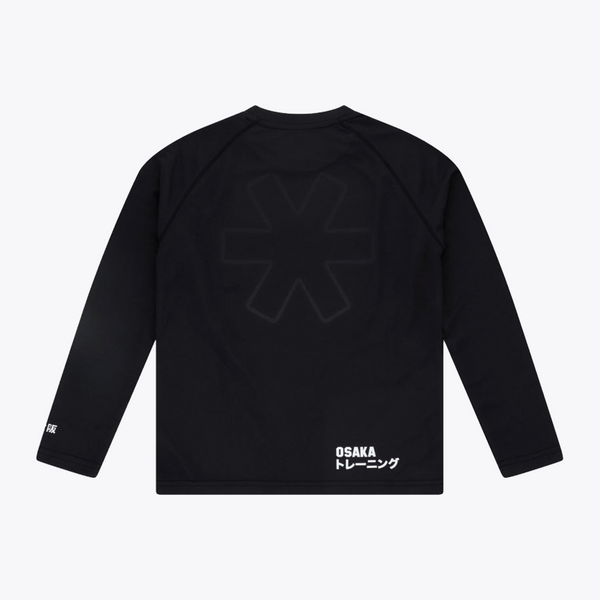 Black long-sleeve training top shown from the back, featuring a large tonal dark gray geometric logo on the upper back and white 'OSAKA トレーニング' text near the lower right hem, photographed on a light gray background. #Black