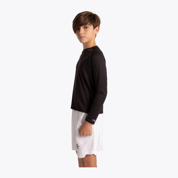 A child model shown in side profile wearing a black long-sleeve athletic shirt and white shorts against a plain light gray studio background. #Black