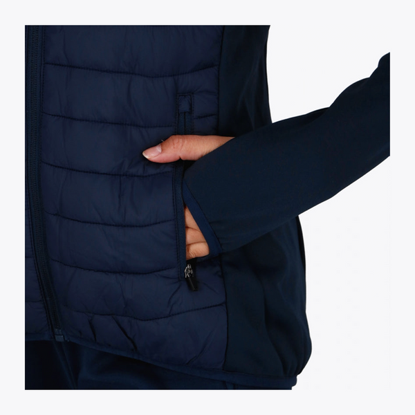 Close-up of a person wearing a dark navy quilted puffer vest, showing a hand reaching into a side zip pocket against a plain light background. #Navy