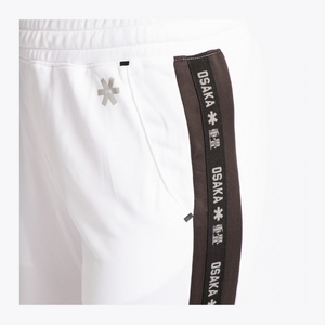 White athletic shorts with a dark brown side stripe featuring white 'OSAKA' text and star motifs, plus a small gray logo near the waistband. #White