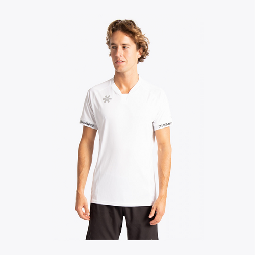 A man wearing a white short-sleeve athletic t-shirt with a gray logo on the left chest and sleeve trim, paired with black shorts, against a light gray background. #White